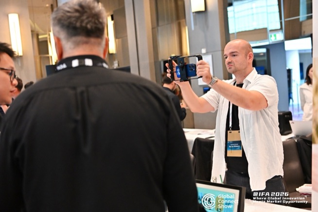 An attendee films a demo on a smartphone at GCS @IFA 2026